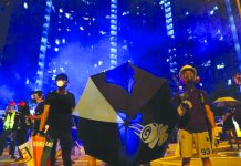 Hong Kong police fire tear gas as protests roiled again A man reacts in tear gas as riot police try to disperse them at Wong Tai Sin, a residential area, after an anti-extradition bill protest in Hong Kong, China August 4, 2019. REUTERS