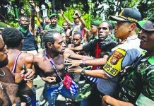 Papuan activists scuffle with police and soldiers during a rally near the presidential palace in Indonesia. GULFTODAY