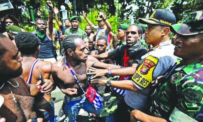 APTOPIX Indonesia Papua Protests Papuan activists scuffle with police and soldiers during a rally near the presidential palace in Indonesia. GULFTODAY