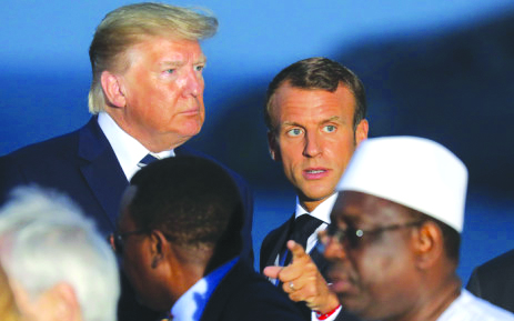 Macron Trump U.S. President Donald Trump (L) and France’s President Emmanuel Macron talk prior to a family picture with G7 leaders and guests, on the second day of the annual G7 summit in Biarritz, south-west France on Aug. 25, 2019. AFP