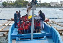 BACK IN BUSINESS: Motorboats resume trips under stringent rules WEARING LIFEJACKET IS A MUST. Philippine Coast Guard personnel make sure the passengers of this Guimaras-bound motorboat are wearing lifejackets before leaving the Iloilo Ferry Terminal. Passengers should wear lifejackets at all times throughout the voyage, according to the Maritime Industry Authority. IAN PAUL CORDERO/PN
