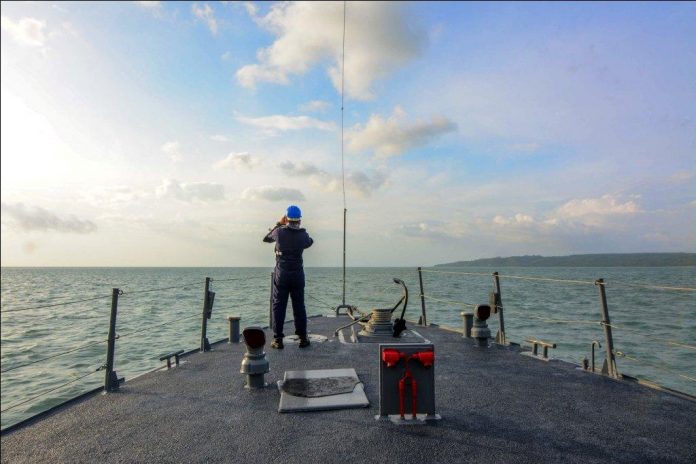 SEARCH FOR SURVIVORS. Onboard BRP Alfredo Pecson, a Philippine Navy personnel scans the vast expanse of the Iloilo Strait in the hope of finding more survivors from Saturday’s (Aug. 3, 2019) capsizing of three motorboats hit by a squall. Twenty-eight persons have so far been confirmed to have drowned. IAN PAUL CORDERO/PN