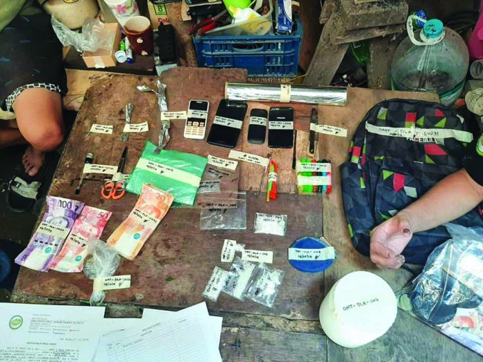 Operatives of the Philippine Drug Enforcement Agency seize these suspected shabu, cellphones, marked money, and drug paraphernalia in San Carlos City, Negros Occidental. PDEA REGION 6