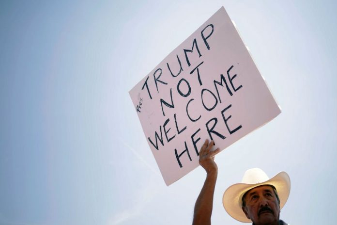 Trump Protesters A man takes part in a rally against the visit of the U.S. President Donald Trump after a mass shooting at a Walmart store, in El Paso, Texas, U.S., Aug. 7, 2019. REUTERS