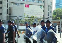 Turkish police walk in front of the Metropolitan Municipality headquarters in Diyarbakir, Turkey, Aug. 19, 2019. REUTERS