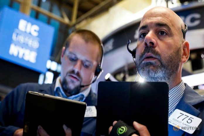 Wall Street Traders work on the floor at the New York Stock Exchange (NYSE) in New York, U.S., August 7, 2019. REUTERS