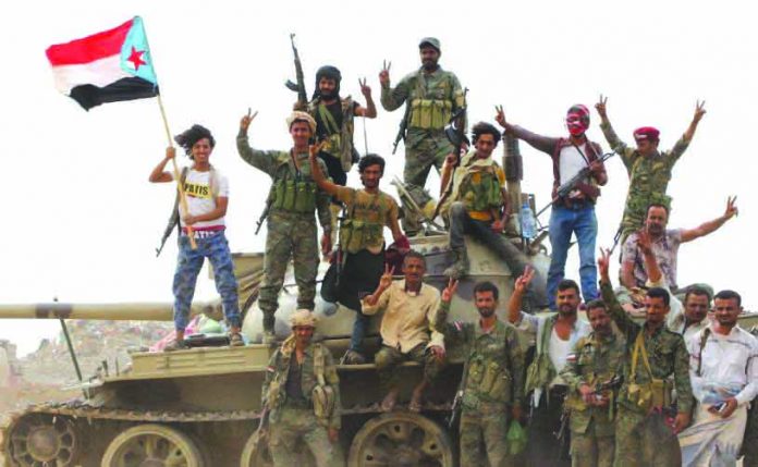 Yemen Military Camps Members of UAE-backed southern Yemeni separatist forces stand atop a tank during clashes with government forces in Aden, Yemen August 10, 2019. REUTERS