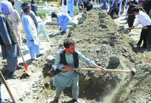 Afghan men dig grave during a mass funeral after a suicide bomb blast at a wedding in Kabul, Afghanistan Aug. 18, 2019. REUTERS