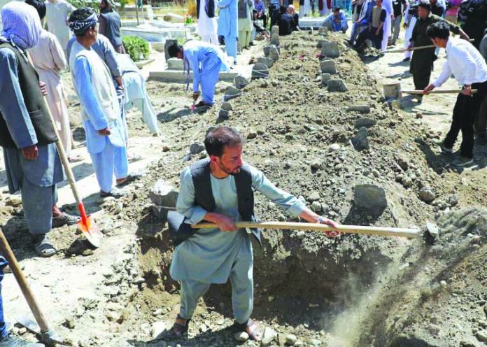 suicide bomb attack wedding Afghan men dig grave during a mass funeral after a suicide bomb blast at a wedding in Kabul, Afghanistan Aug. 18, 2019. REUTERS