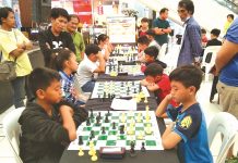 Elementary chess players in action during the 2019 Inter-Elementary School Dalawahan Chess Competition at the GT Town Center in Pavia, Iloilo. PAVIA CHESSERS PHOTO
