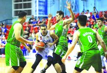 Aaron Black of AMA Online Education Titans extricates himself against the Hazchem Green Warriors defenders. PBA PHOTO