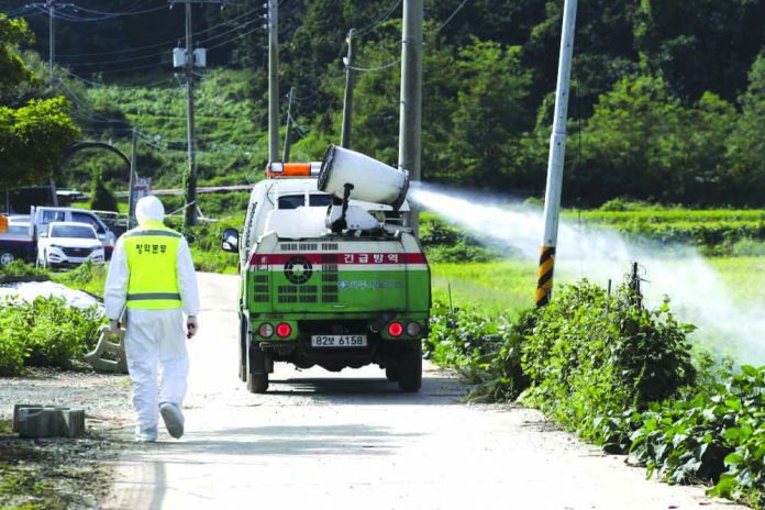 Disinfectant solution is sprayed from a vehicle as a precaution against African swine fever at a pig farm in Paju, South Korea, Tuesday, Sept. 17, 2019. AP