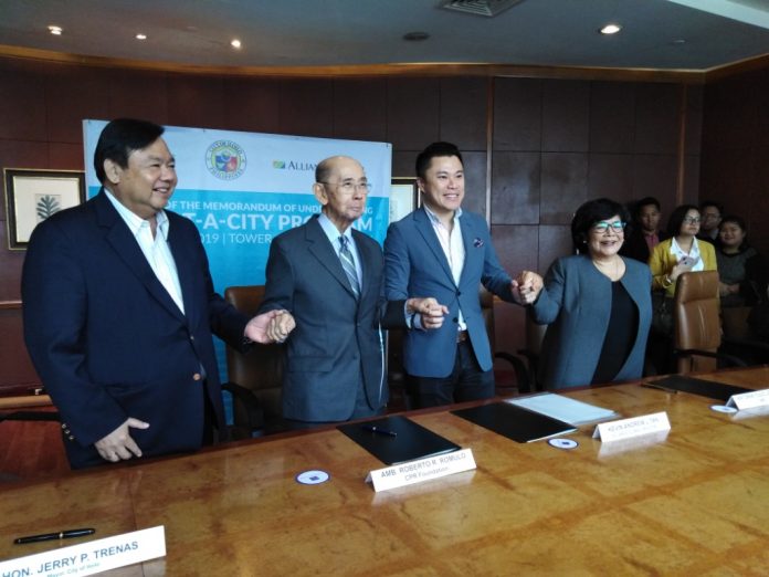 Alliance Global Group Inc. Iloilo City (From left) Iloilo City’s Mayor Jerry Treñas, Ambassador Roberto R. Romulo (National Resiliency Council convenor), Kevin Andrew Tan (CEO, Alliance Global Group Inc. and chief strategy officer, Megaworld) and National Resiliency Council president Ma. Antonia Yulo Loyzaga join hands in a symbolic gesture of partnership after the signing of a memorandum of understanding for the Adopt-a-City Initiative for climate and disaster preparedness. The goal is to make Iloilo City more resilient.