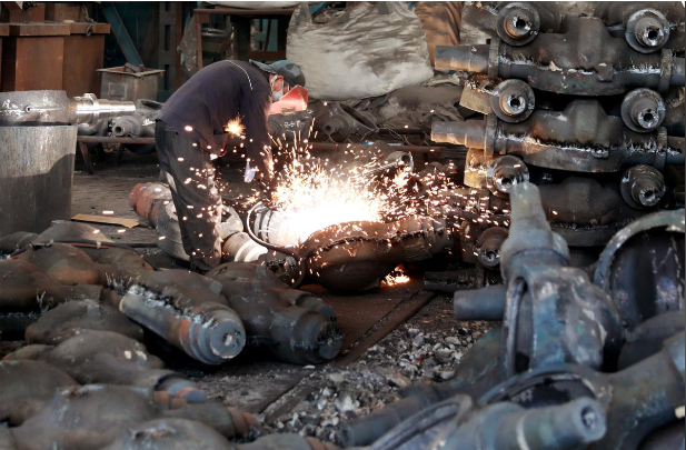 Automobile shop A worker welds automobile parts at a workshop manufacturing automobile accessories in Huaibei, Anhui province, China June. 28, 2019. REUTERS