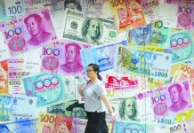 China rejects Trump criticism on trade In this Aug. 6, 2019, file photo, a woman walks by a money exchange shop decorated with different countries currency banknotes at Central, a business district in Hong Kong. AP