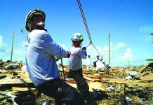 Thousands in Bahamas struggle to find work after Dorian Members of the fire rescue team Task Force 8, from Gainesville, Florida, help remove a body one week after Hurricane Dorian hit The Mudd neighborhood in the Marsh Harbor area of Abaco Island, Bahamas, Monday, Sept. 9, 2019. AP