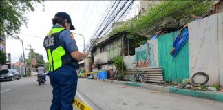 ROAD TO PERDITION. A police officer checks this road in Barangay Rizal, Lapuz, Iloilo City where a drug suspect was ambushed by two motorcycle-riding gunmen yesterday afternoon, Sept. 18, 2019. The 42-year-old Roy Goco died while being rushed to the West Visayas State University Medical Center. Goco was arrested in a buy-bust operation of the police in November 2016 then charged with violating the Comprehensive Dangerous Drugs Act of 2002. IAN PAUL CORDERO