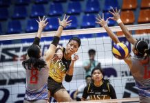 Ejiya`Laure of the University of Santo Tomas Golden Tigresses scores an attack against Arellano University Lady Chiefs defenders. ABS CBN SPORTS PHOTO