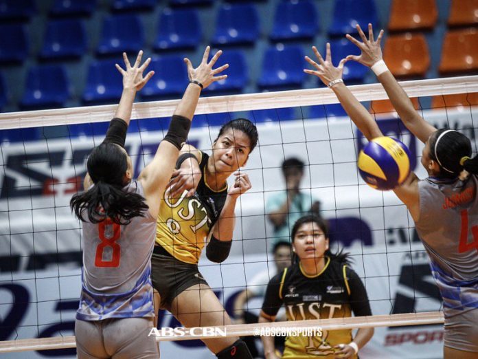 Ejiya`Laure Ejiya`Laure of the University of Santo Tomas Golden Tigresses scores an attack against Arellano University Lady Chiefs defenders. ABS CBN SPORTS PHOTO