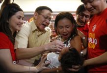 Health secretary Francisco Duque III (second from left) administers anti-polio vaccine to a child in Quezon City on Sept. 20 in a campaign to end the resurgence of the deadly disease. BULILIT MARQUEZ/AP/TIME.COM