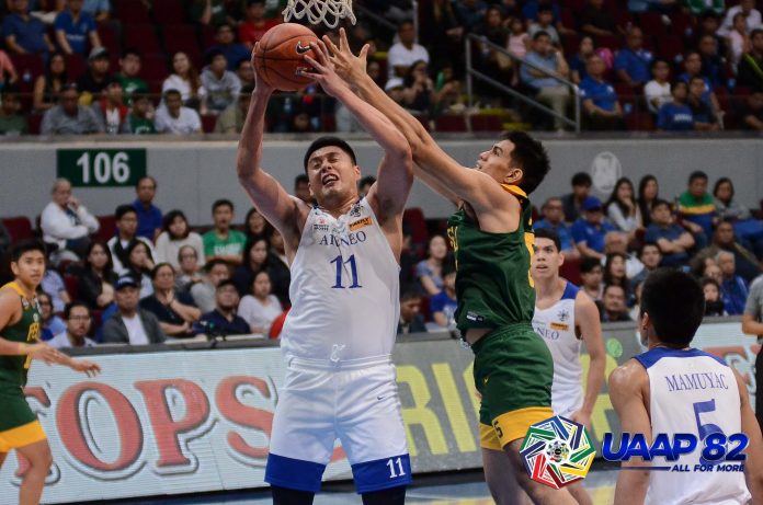 George Isaac Go Ateneo Blue Eagles’ George Isaac Go is clobbered by a Far Eastern University Tamaraws defender while trying to go for an inside basket. UAAP PHOTO