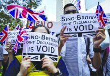 Hong Kong protesters defy ban to march in shopping area Protesters hold placards and wave British flags during a peaceful demonstration outside the British Consulate in Hong Kong, Sunday, Sept. 15, 2019. AP