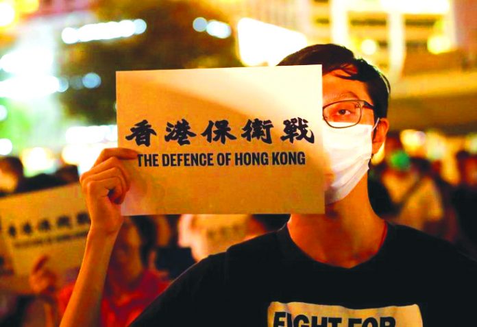 Hong Kong Protest A man covers his eye with a placard as he attends a protest in Hong Kong, China on Aug. 30, 2019. REUTERS