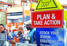 A worker at Home Depot helps customers with storm supplies as people rushed to stock up on necessities ahead of the arrival of Hurricane Dorian in Kissimmee, Florida, U.S. Aug. 30, 2019.