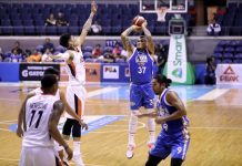 NLEX Road Warriors’ JR Quinahan hoists a triple as Meralco Bolts’ Raymond Almazan goes for a block. PBA MEDIA BUREAU PHOTO