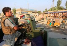 Afghanistan bolsters security amid Taliban threats A policeman stands guard at a checkpoint in Jalalabad, Afghanistan on Sept. 26. The country deployed over 100,000 troops and police to secure polling stations in a presidential election. REUTERS/PARWIZ