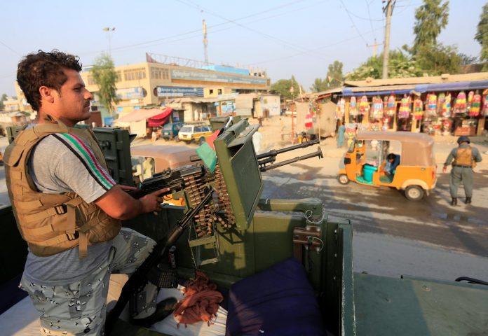 A policeman stands guard at a checkpoint in Jalalabad, Afghanistan on Sept. 26. The country deployed over 100,000 troops and police to secure polling stations in a presidential election. REUTERS/PARWIZ
