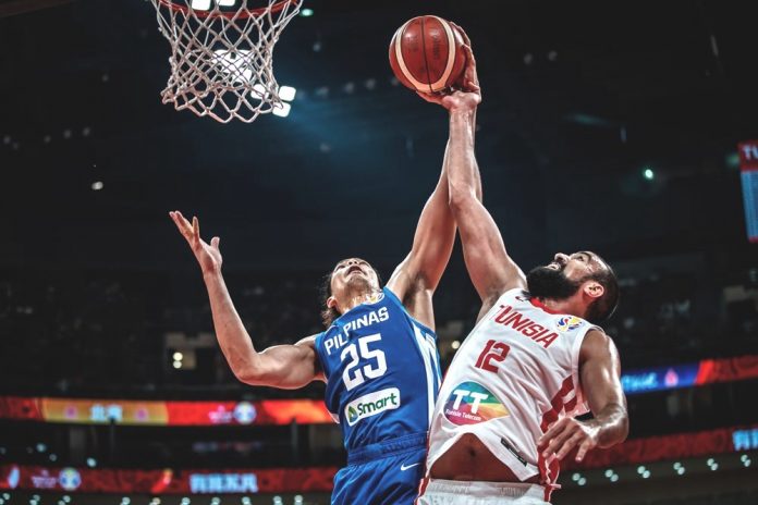 Japeth Aguilar of the Philippines blocks the shot attempt of Makram Ben Romdhane of Tunisia. FIBA PHOTO