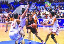 Kobe Paras of the University of the Philippines Fighting Maroons protects the ball against three University of the East Red Warriors defenders. UAAP PHOTO