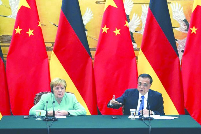 Chinese Premier Li Keqiang gives a speech during the press conference at the end of the meeting with Chancellor of Germany Angela Merkel, left, at The Great Hall Of The People in Beijing, on Friday, Sept. 6, 2019. AP