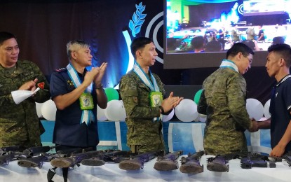 Military to dismantle 2 Negros rebel fronts Army officials applaud the surrender of a firearm of former communist rebel ‘Ka Joros’ to Brigadier General Eric Vinoya (second from right) during the North Negros Peace Summit in Escalante City on Friday. NANETTE L. GUADALQUIVER/PNA
