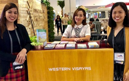 NegOcc introduces new tourism sites Negros Occidental supervising tourism operations officer Cristine Mansinares (right) with the Department of Tourism-Western Visayas staff during the 30th Philippine Travel Mart at the SMX Convention Center at Mall of Asia Complex in Pasay City. PNA
