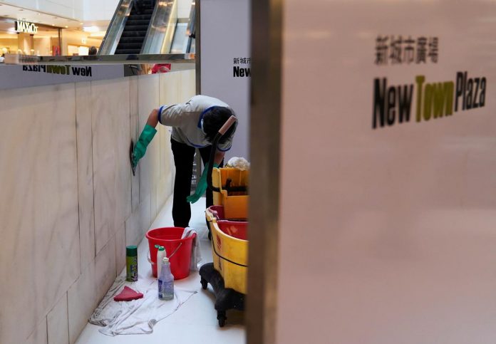 A worker cleans graffiti at the New Town Plaza in Sha Tin, Hong Kong, China on Sept. 23 after anti-government protesters left marks on the wall. REUTERS