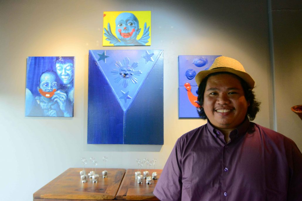 Artist Agos Payapa with his masterworks.