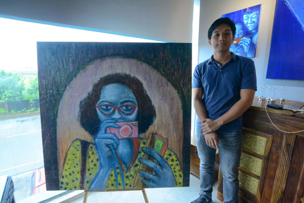 Bam Garibay beside his masterwork, the young artist also curated the inaugural Omriel exhibit “Blood Line.”