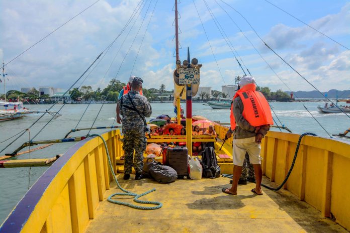Philippine Coast Guard Guimaras A Philippine Coast Guard personnel (standing, left) is making sure all the passengers of this Guimaras-bound motorboat are wearing lifejackets before allowing the boat to leave the Iloilo Ferry Terminal in Iloilo City. The lifejackets must be worn at all times throughout the voyage. IAN PAUL CORDERO/PN