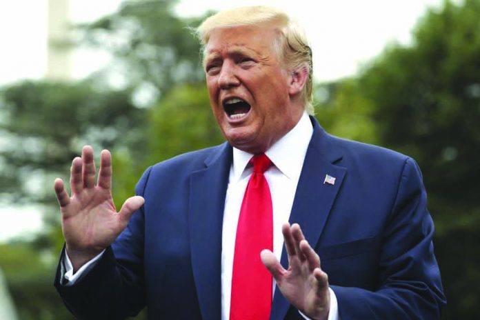 President Donald Trump speaks to members of the media on the South Lawn of the White House in Washington, Monday, Sept. 9, 2019, before boarding Marine One for a short trip to Andrews Air Force Base, Md., and then on to North Carolina. AP