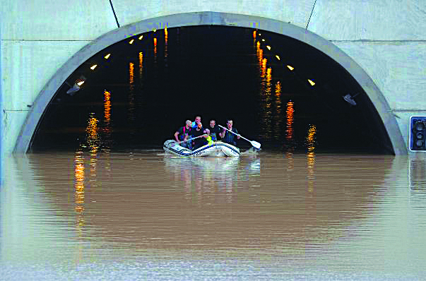 Responders on a boat rescue a person stranded inside a flooded tunnel in Pilar dela Horadada, Spain on Sept., 2019. REUTERS