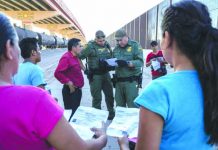 Top US court backs asylum crackdown US Customs and Border Protection agents in May 2019 check documents in El Paso, Texas, from a small group of migrants who crossed from Mexico. AFP