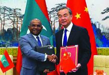 Chinese Foreign Minister Wang Yi and Foreign Minister of Maldives Abdulla Shahid shake hands and hold the signed agreements during the signing ceremony at the end of the meeting at Diaoyutai State Guesthouse, in Beijing, China Sept. 20, 2019. REUTERS