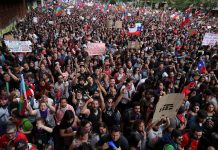 1-million Chileans march in Santiago Demonstrators march with flags and signs during a protest against state economic model in Santiago, Chile on Oct. 25. REUTERS/IVAN ALVARADO
