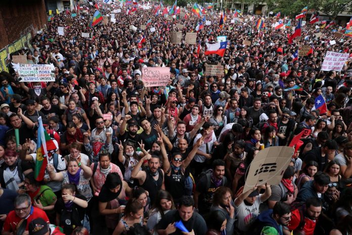 1-million Chileans march in Santiago Demonstrators march with flags and signs during a protest against state economic model in Santiago, Chile on Oct. 25. REUTERS/IVAN ALVARADO