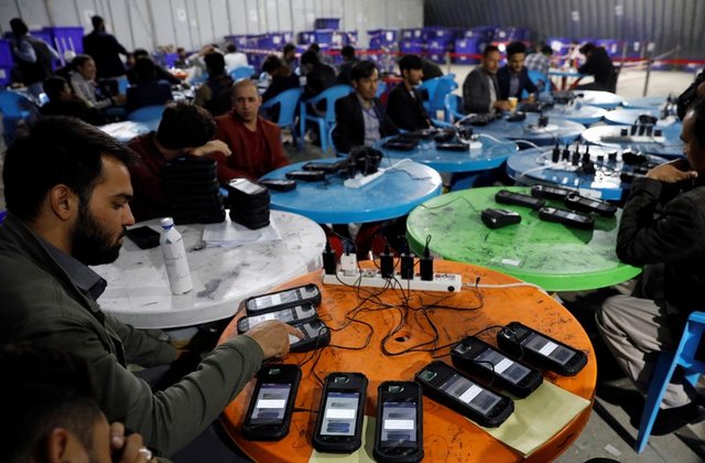 Afghan election commission workers Afghan election commission workers transfer data from biometric devices to the main server at a warehouse in Kabul, Afghanistan on Oct. 7. REUTERS/MOHAMMAD ISMAIL