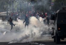 Demonstrators clash with security forces in Santiago, Chile on Saturday. AFP