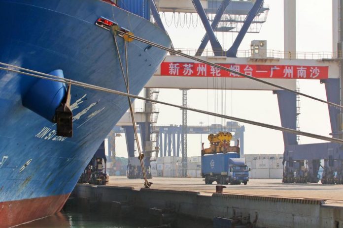 China A crane lifts a container from a truck next to a cargo vessel at a port in Yantai, Shandong province, China Oct. 17. China’s economy expanded at its slowest rate in nearly three decades during the third quarter as it was hit by the long-running United States trade war and cooling domestic demand. REUTERS