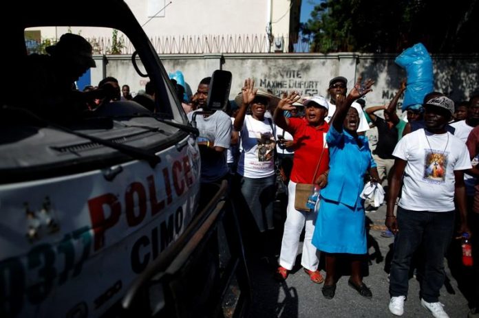 Christ Roi Church People shout next to a police truck outside the Christ Roi Church before a march was organized in Port-au-Prince, Haiti on Oct. 22. REUTERS/ANDRES MARTINEZ CASARES